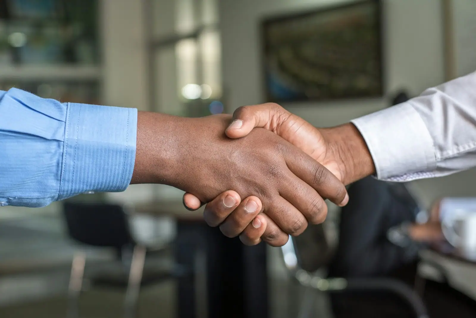 Hiring manager conducting a technical interview with a candidate in a meeting room